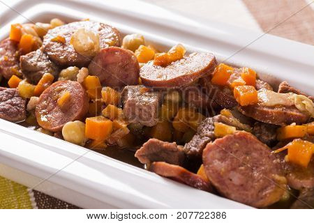 South American Cuisine: Puchero Soup With Sausage. Close-up In A Pot On The Table.