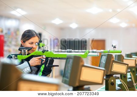girl the athlete with a rifle at sports firing competitions