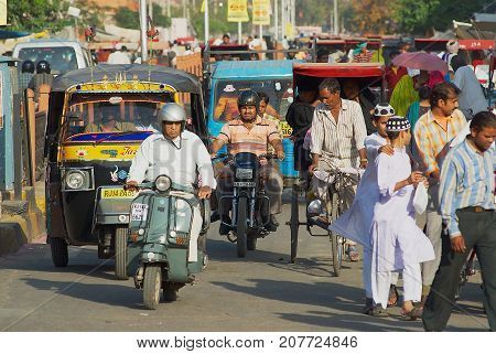 JAIPUR, INDIA - MARCH 29, 2007: Unidentified people move by the strew in a morning rush hour in Jaipur, India.