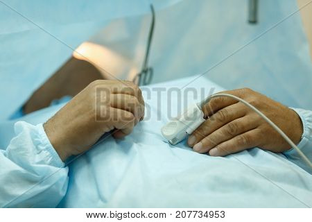 The patient lies on the operating table