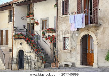 PESCOCOSTANZO ITALY - AUGUST 18 2015: Nice facades in steep alley. The mountain village - about 1400 m above sea - Pescocostanzo in the region of Abruzzo Italy