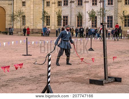 Gatchina St. Petersburg Russia - September 30 2017: Horse show of Cossacks on the parade ground of the Gatchina Palace. The Cossack clicks two whips.