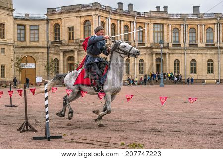 Gatchina St. Petersburg Russia - September 30 2017: Horse show of Cossacks on the parade ground of the Gatchina Palace. The Cossack rides with a sword.