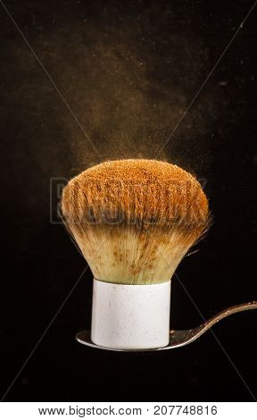 fluffy brush for powder or blush on a black background