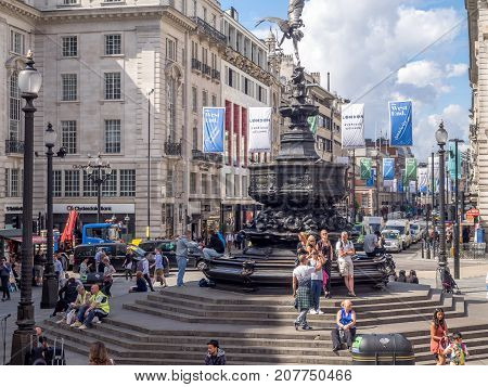 LONDON UK - AUG 1: People enjoying the sun at Piccadilly Circus on August 1, 2017 in London, England. The Piccadilly Circus area is popular for tourists, shopping and the theatre.
