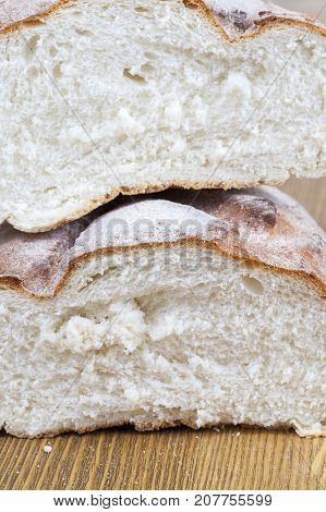 Two Half Freshly Baked Wheat Bread, Lying On Top Of Each Other. Photo Close-up Of Half Loaf On A Woo