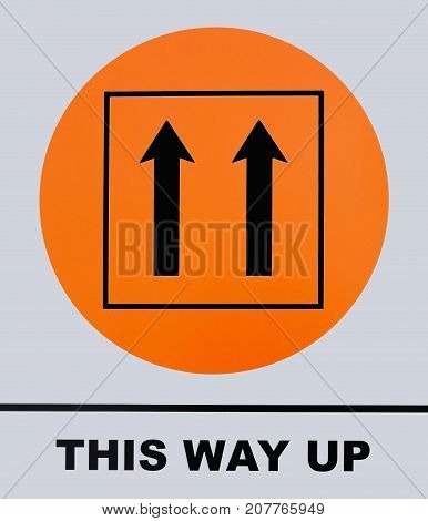 Photo of This Way Up sign isolated on white background. This photo was taken from the sign board.