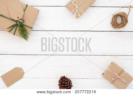 Christmas background. Christmas frame made of present gifts box with decoration rustic elements on white wooden. Creative flat lay top view design