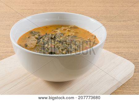 Thai Cuisine and Food Delicious Thai Spicy Coconut Milk Cream Based Curry with Cassia Leaves and Grilled Beef Fillet.