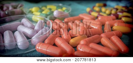 Many medicines pills capsules of diferent size
