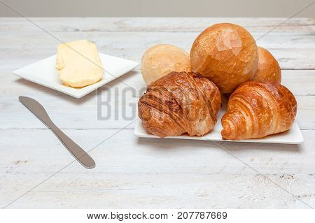 an Hard roll call it in Dutch Pistolee and croissant whit knife and butter