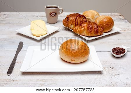 an Hard roll call it in Dutch Pistolee and croissant whit knife and butter