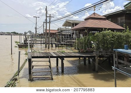 Outdoor view in summer of Exotic Thai Houses along the river in suburb area.