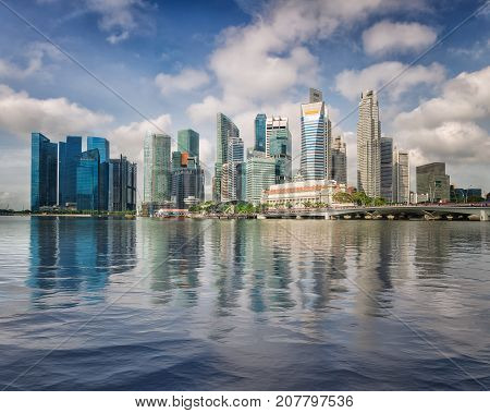 Singapore business center skyline and blusky in day time with reflection on water Singapore city