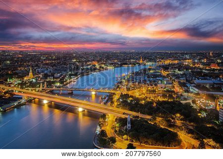 Bangkok river with sunset time from roof top of high building Wat arun Pho temple rama one bridge and thonburi city in this view.