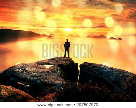 Hiker Watching To Autumn  Sun At Horizon . Beautiful Moment The Miracle Of Nature. Colorful Mist In
