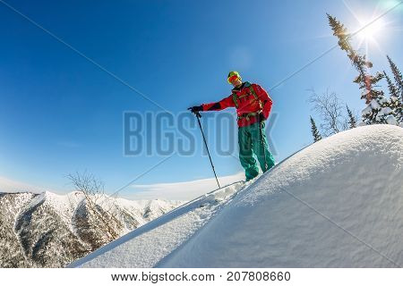 Man Standing At Top Of Ridge. Ski Touring In Mountains. Adventure Winter Freeride Extreme Sport