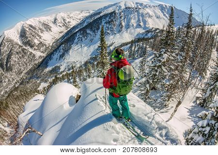 Man Standing At Top Of Ridge. Ski Touring In Mountains. Adventure Winter Freeride Extreme Sport