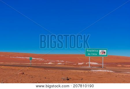 View on sign by the border to Chile and Bolivia in the Andes