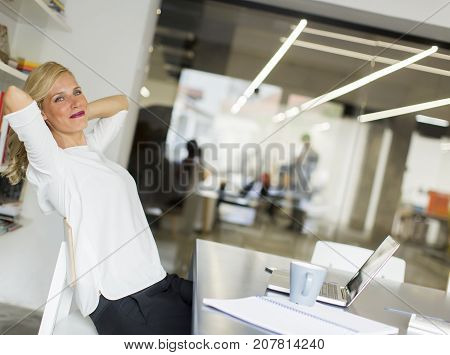 Businesswoman In The Office Taking A Break And Doing A Neck Exercise