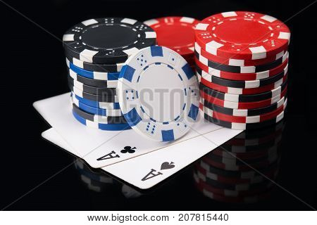 Two aces on a black background with a big bet of game money