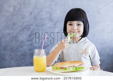 Cuttle Black Hair Little Girl Having Breakfast And Eat Lettuce