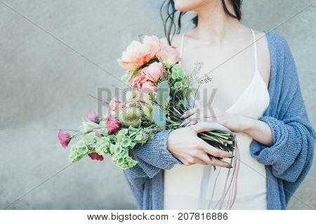 Woman holding a decorative bouquet in outdoor