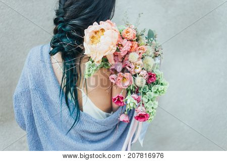Woman holding a decorative bouquet in outdoor