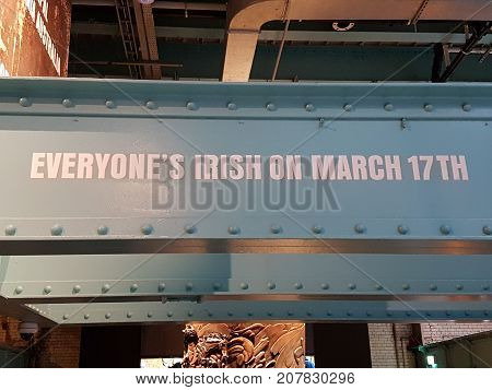 DUBLIN IRELAND - AUGUST 9 2017-Everyone's Irish on March 17th sign on huge steel girder in Guinness Brewery Museum.