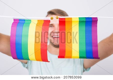 Young man hold a rainbow flag, gey boy.