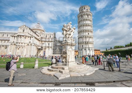 PISA, ITALY - SEPTEMBER 20, 2014: The world famous Piazza dei Miracoli in Pisa, Tuscany. The construction of the cathedral was begun in 1064.