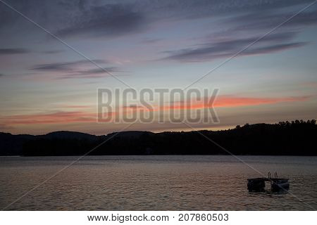 Sunset and colorful clouds over Squam Lake, New Hampshire