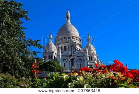 The basilica Sacre Coeur is a Roman catholic church located at the summet of the butte Montmartre , the highest point in Paris.