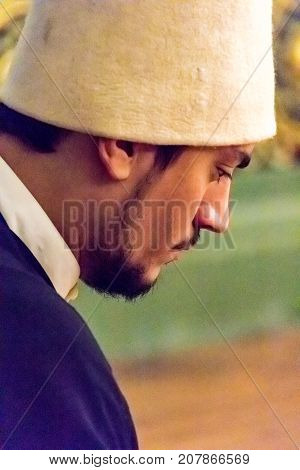 Sufi Master (whirling Dervish Leader) Bows Head Prior To Dance