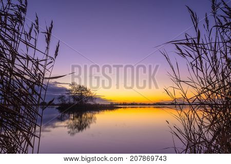 Blue and yellow Sunset over a Tranquil lake in Friesland Netherlands