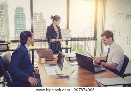 Businesswoman Presentation To A Group In Meeting.