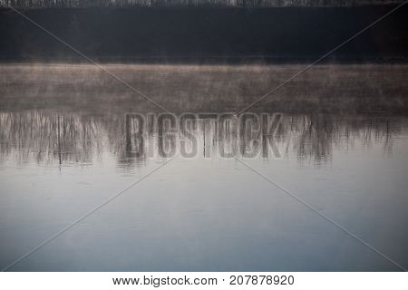 Morning on the river early morning reeds mist fog and water surface on the river