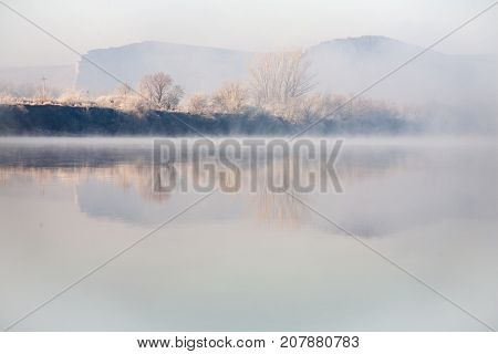 Morning on the river early morning reeds mist fog and water surface on the river