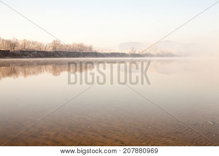 Morning on the river early morning reeds mist fog and water surface on the river