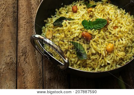 South Indian Curry leaves rice / Karuvepilai sadam served in a Kadai