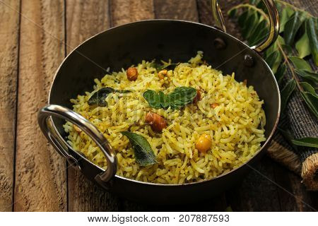 South Indian Curry leaves rice / Karuvepilai sadam served in a Kadai