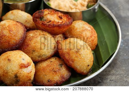 Kuzhi Paniyaram served with coconut chutney and sambar- South Indian breakfast with black lentils and rice