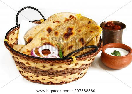 Aloo Paratha served in a basket isolated on white selective focus