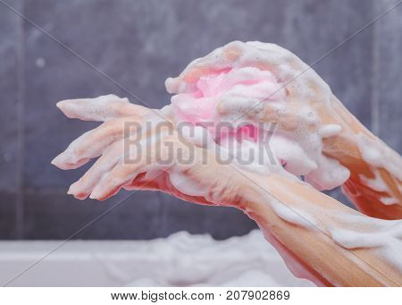 Close Up Of Woman Washing Hand With Sponge In Bathtub In The Bathroom