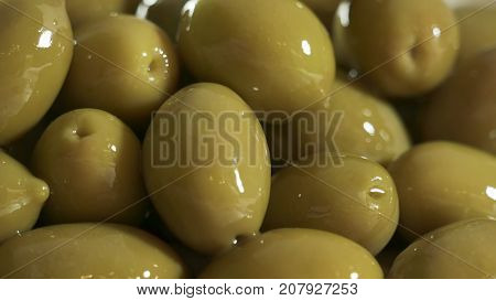 Large shiny green olives macro for background