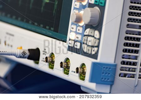 Fragment of a modern digital oscilloscope. Scientific measuring equipment. Abstract industrial background.