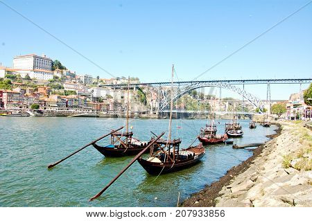 31 may 2013-oporto-portugal-old boats carrying oporto wine along the douro river