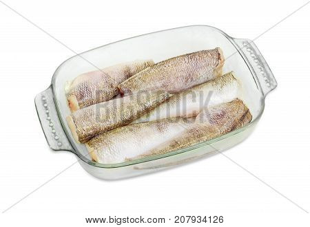 Several uncooked carcasses of the notothenia fish without of a heads and tails and with peeled scales and prepared for baking in the rectangular glass for baking on a white background