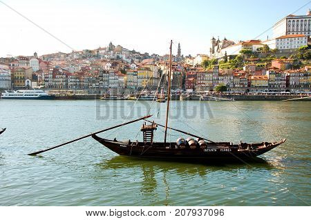 31 may 2013-oporto-portugal-old boats carrying oporto wine along the douro river