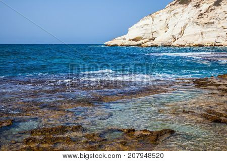 Rocks of white limestone on the shores of the Mediterranean Sea. Geological phenomenon in the north of Israel. The grottoes of Rosh Ha Nikra